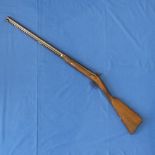 An antique single barrel percussion Shotgun, the 68cm Damascus barrel with ramrod and working