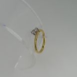 A two stone diamond Ring, set on the cross in 18ct yellow and white gold, each stone approx 0.075ct,
