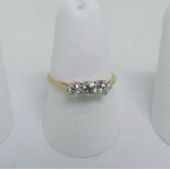 A small three stone diamond Ring, the unmarked yellow gold shank tested as 18ct gold, Size O, approx