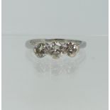 A three stone diamond Ring, the centre stone approx. 0.3ct, with a smaller stone on each side,