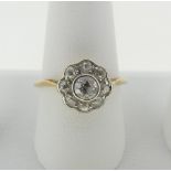 A diamond Cluster Ring, the central old cut stone approx ¼ct, surrounded by eight smaller stones,