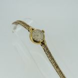 A 9ct yellow gold lady's Wristwatch, dial signed for the International Watch Co., with baton