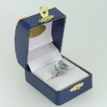 An aquamarine and diamond Dress Ring, the step cut aquamarine 13.75mm x 11.75mm with two diamonds on