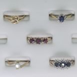 Five 9ct yellow gold Rings; one set three garnets, Size O, one a sapphire and white paste triple