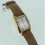 An 18ct gold Omega gentlemen's Wristwatch, marked Turler, the rectangular gold case with silvered