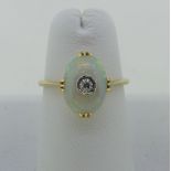 A small opal and diamond Ring, the oval opal 10.5mm x 7.5mm, set with a diamond point centre, all