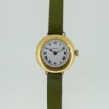 An 18ct gold Peertone lady?s Wristwatch, the circular case with white enamel dial and black Arabic