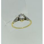 A single stone diamond Ring, the circular cut stone approx 0.52ct, with three graduated small