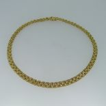 An 18ct yellow gold Collar Necklace, with slightly graduated fancy links, the front 7mm wide, the