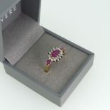 A ruby and diamond cluster Ring, the oval central ruby claw set in white gold within a surround of