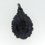 An antique Jet Pendant, of teardrop shape with carved wheatsheaf centre and a foliate border, 6cm
