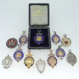 Two 9ct gold Prize Fobs, both enamelled for 'Redhill & Dist Football League', the yellow gold