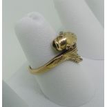 A 9ct gold Dolphin Ring, the head and tail crossing over at the front, with ruby eyes, Size N, 3.8g.