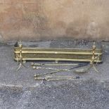 An antique pierced brass Fender, with pierced decoration on paw feet, 120cm wide, together with a