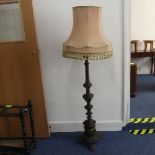 An early 20thC continental carved walnut Standard Lamp, with triangular shaped balusters, raised