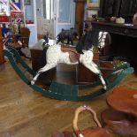 An early 20thC grey dapple painted Rocking Horse, with mane, leather saddle and tack, on wooden