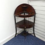 A Georgian mahogany corner Washstand, with one drawer and two dummy drawers, raised on splayed legs,
