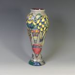 A Moorcroft 'Balloon' pattern Baluster Vase, tube lined decoration on grey ground, with factory