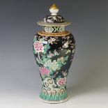 A 20thC Japanese porcelain famille noir Temple Jar, with black ground and enamelled floral