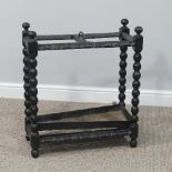 A Victorian carved dark oak division Umbrella Stand, with drip tray, brass carrying handle and