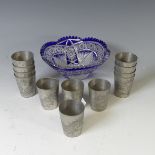 A set of twelve 20thC Chinese pewter shot beakers, each decorated with scrolling dragons, stamped '