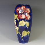 A Walter Moorcroft 'Hibiscus' pattern Baluster Vase, tube lined decoration on cobalt blue ground,
