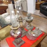 A Victorian cast iron and glass Oil lamp, with square shaped foot, together with another similar and