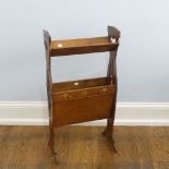 An Arts & Crafts oak floor-standing two tier Book Trough/Magazine Stand, with heart-shaped pierced
