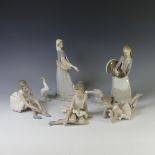 A small quantity of Lladro figurines, to include a Girl holding a goose with a lamb at her feet, a