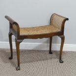 An antique caned Dressing Table Stool, on cabriole legs, damage to veneer on one side, W 74cm x D