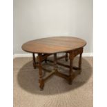 An Oak Gateleg Table, with a drawer to either end on turned legs, split to top, W 149cm x D 130cm