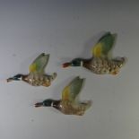 A set of three Keele St Pottery flying ducks, graduating in size, together with a silver plated