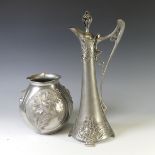 An Art Nouveau style pewter lidded Jug, with shaped handle and decorated with busts of ladies,