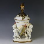 A Victorian Moore pottery Oil Lamp, the base with cherubic figural supports, with foliage in relief,