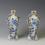 A pair of 18thC blue and white 'Delft' glazed earthenware Vases, of canted baluster form each raised