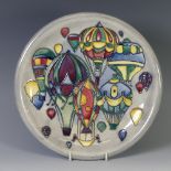 A Moorcroft 'Balloon' pattern Plate, with tube lined decoration on grey ground, of second quality,