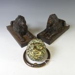 A pair of antique cast metal Fire Dogs, modelled as recumbent Lions, raised on plinth base, W 10cm x