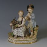 A 19thC Meissen porcelain figure of Autumn, with a young boy standing playing a flute beside a young
