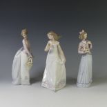 A Lladro figure of 'Afternoon Promenade', together with 'Basket of Love' and 'Innocence in Bloom',