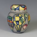 A Moorcroft 'Balloon' pattern Ginger Jar, with tube lined decoration on grey ground, with factory