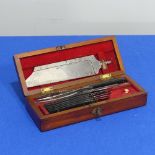 A 19thC mahogany cased Surgeons amputation Set, the set with a detachable steel saw, blades,