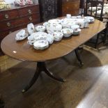 A 19thC-style mahogany twin pedestal extending Dining Table, the top with extra leaf and reeded