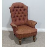 A Victorian upholstered button-back Armchair, raised on turned legs and casters, some woodworm, W