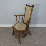 An Arts & Crafts oak framed hexagonal Chair, with tall comb back and arms on spindle supports,