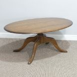 An Ercol oval 'Chester' Coffee Table, on four splayed base, with metal and paper makers label to