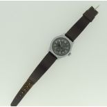 A Timor military issue Wristwatch, the black dial with Arabic hour markers and broad arrow, outer