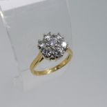A diamond flowerhead cluster Ring, the central brilliant cut stone approx. 0.18ct with six further