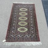Tribal rugs; a light brown ground hand-knotted Persian rug, wool pile on cotton base, woven with one