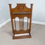 An Arts and Crafts oak Billiards Cue/Stick Stand, with rotating metal cue retainer and drip tray,