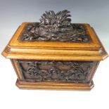 A late 19thC Black Forest carved and stained Tea Caddy, of rectangular form, the hinged lid carved